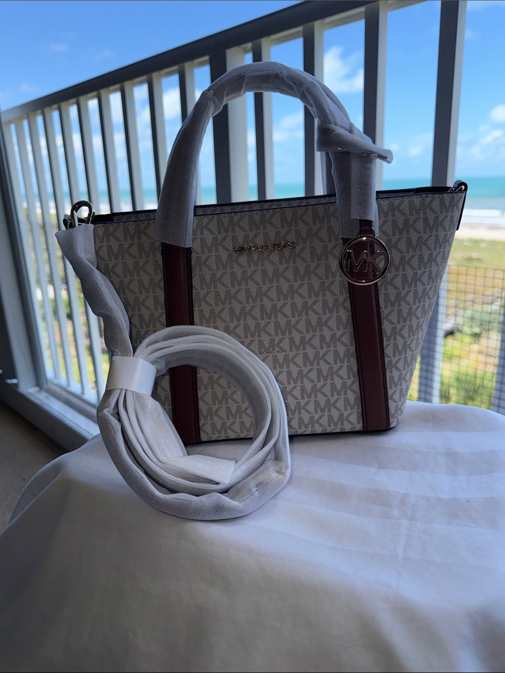 NWT - Michael Kors Vanilla small tote msgr bag with Brown Trim and MK Charm.